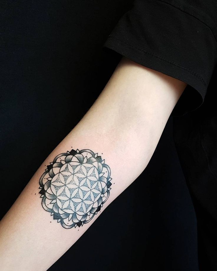 flowers geometrical tattoo, balance tattoo, black background, forearm tattoo