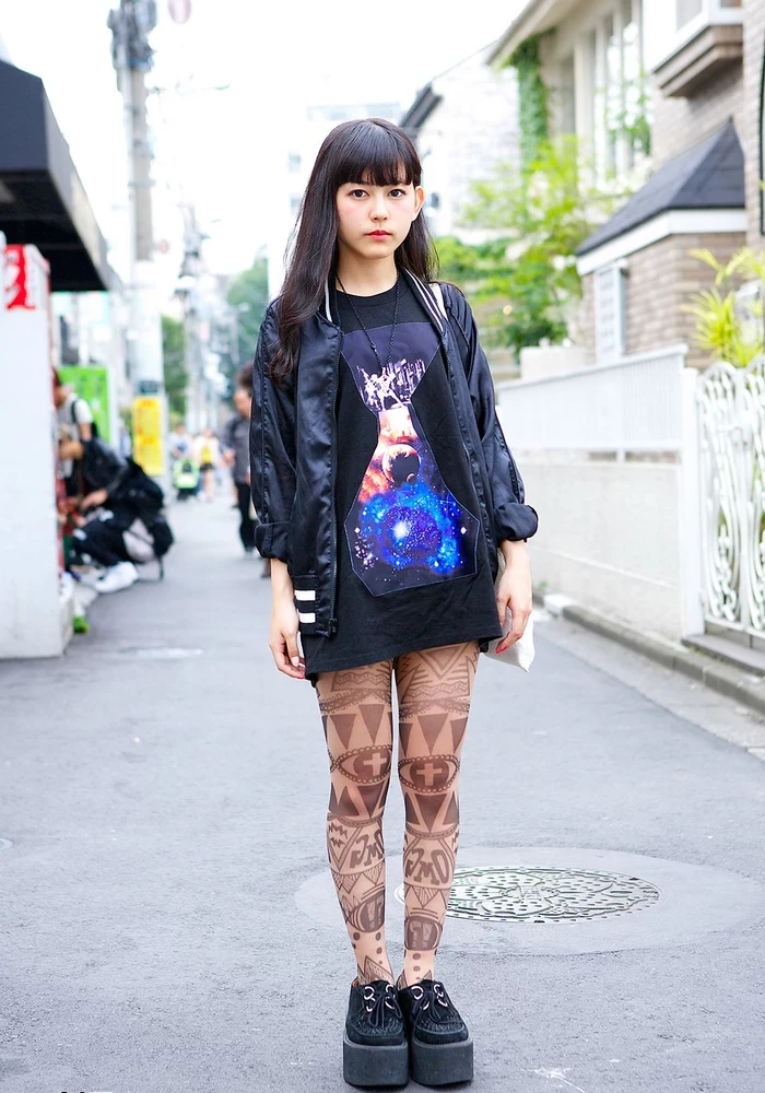 geometrical whole legs tattoo, girl wearing black dress and jacket, back forearm tattoos