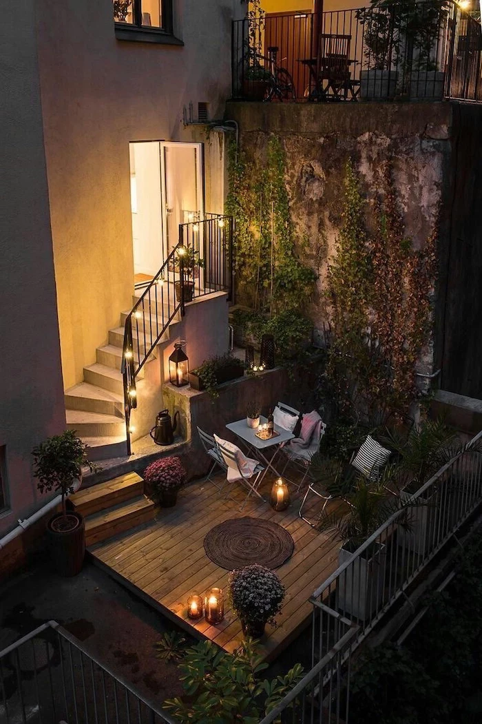 staircase leading to a balcony, small garden ideas, metal garden furniture, decorated with potted plants, crawling ivy