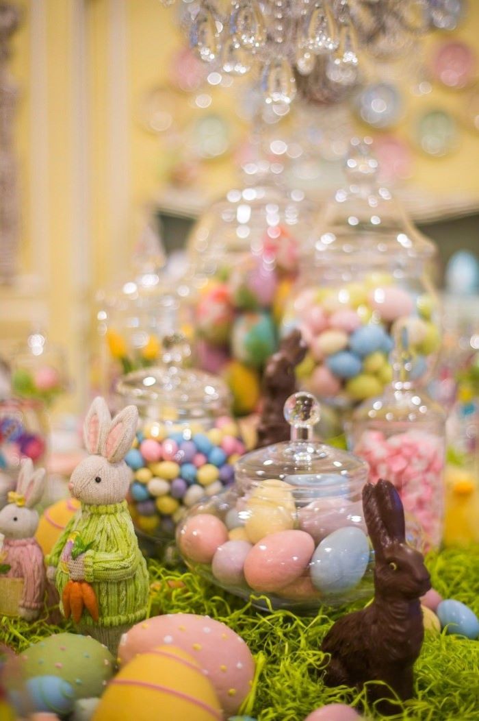 large candy jars, full of dyed and chocolate eggs, easter decorating ideas table setting, bunny figurines