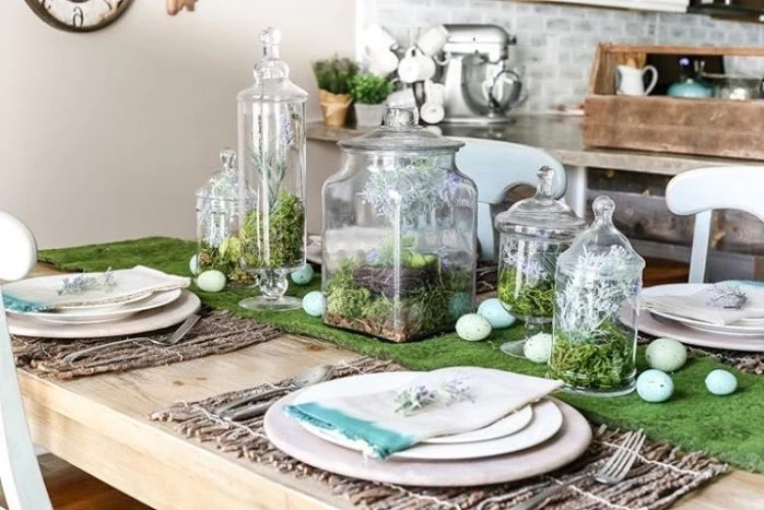 pinterest easter decorations, large glass candy jars, dyed eggs, scattered on a green table runner