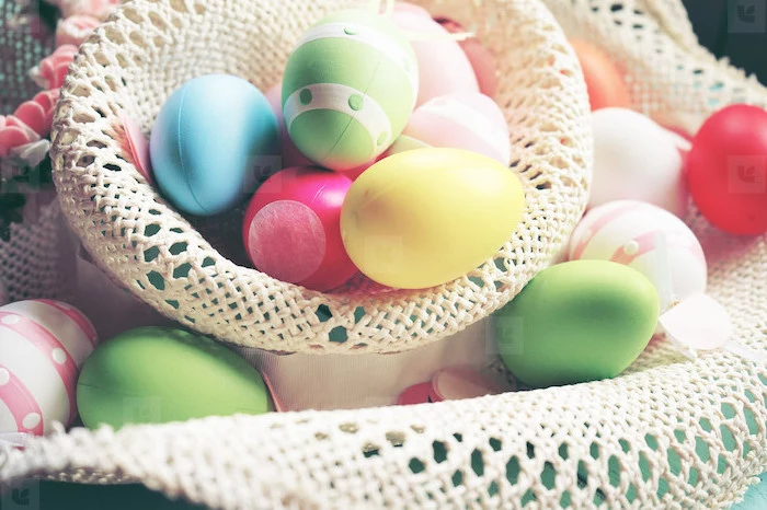 colourful eggs, inside a large sun hat, dying easter eggs with food coloring, eggs scattered everywhere