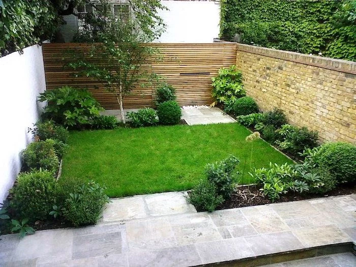 patch of grass, planted bushes and trees around, garden design ideas, cement tiled floor