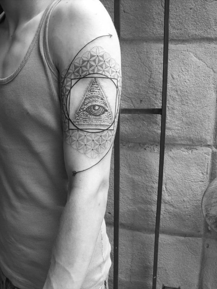 shoulder tattoo, inspired by the illuminati symbol, geometric animal tattoos, man standing in front of a brick wall