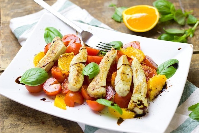 best diet for women, cherry tomatoes, chopped oranges, meat in the salad, on a white plate
