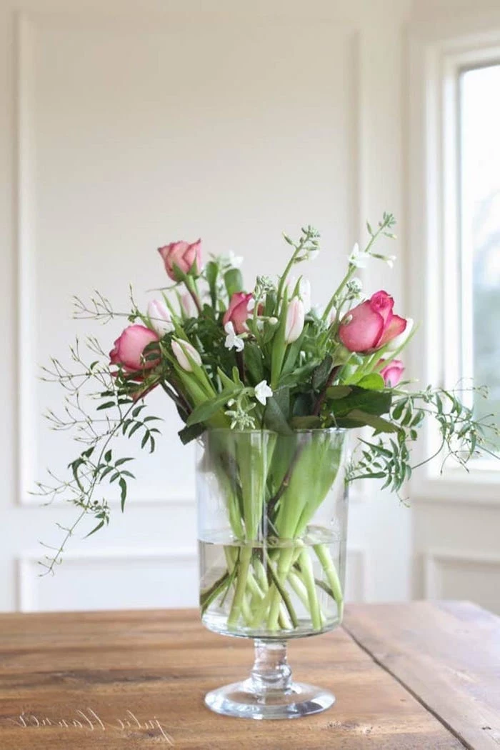 pink roses and white tulips, small bouquet, in a large round vase, silk floral arrangements, on a wooden table