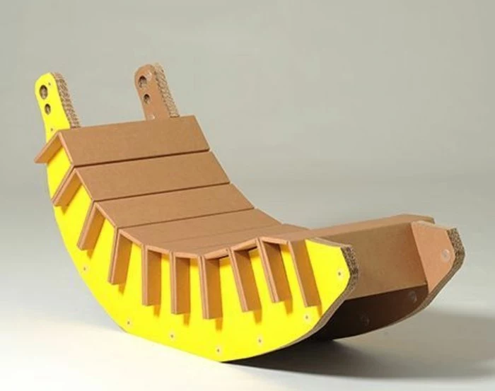 cardboard rocking chair, painted in yellow, in front of a white background, cardboard ideas