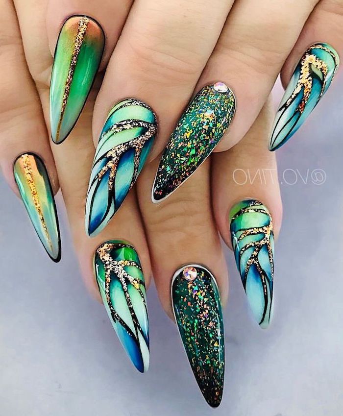 intricate manicure design, green orange and blue nail polishes, very long stiletto nails, nude nail designs