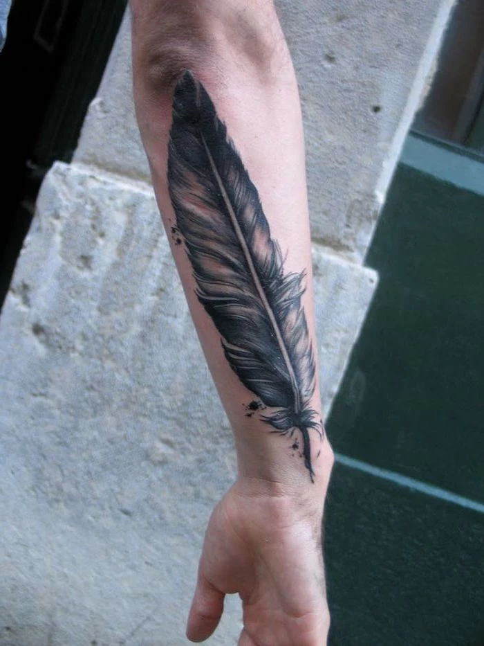 black and white feather, forearm tattoo, arm tattoos for men, cement blocks in the background