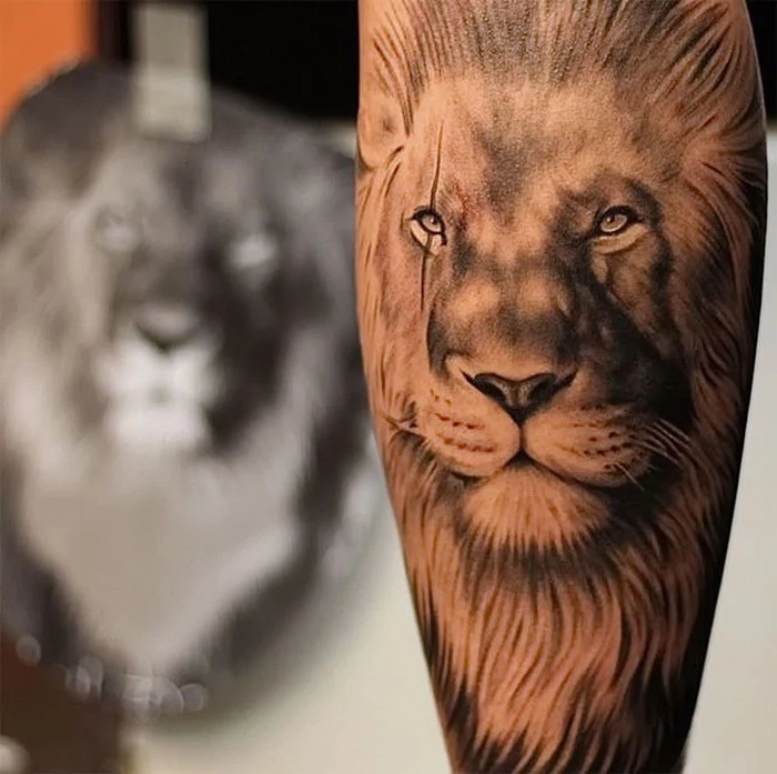 wrist tattoos for men, lion head, black and white tattoo, blurred background