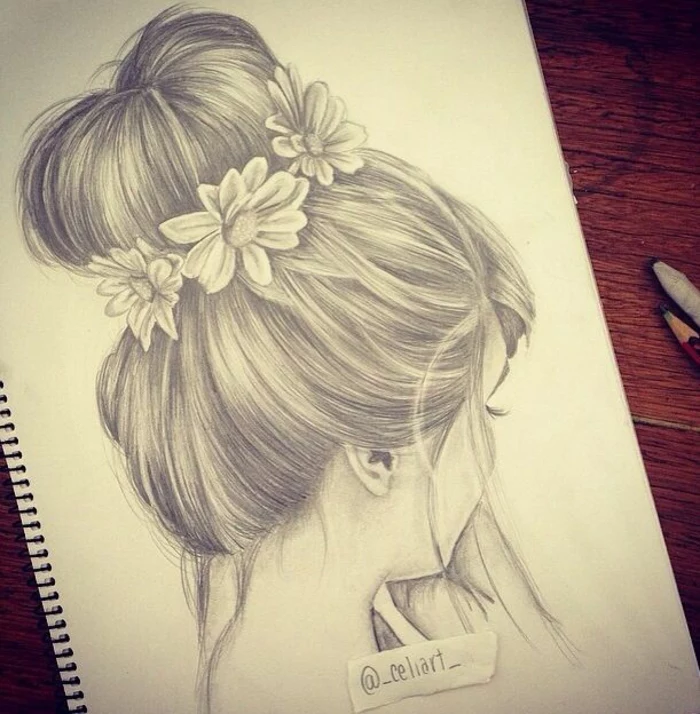 hair in a messy bun, flowers in the bun, black and white girl drawing, white sketchbook