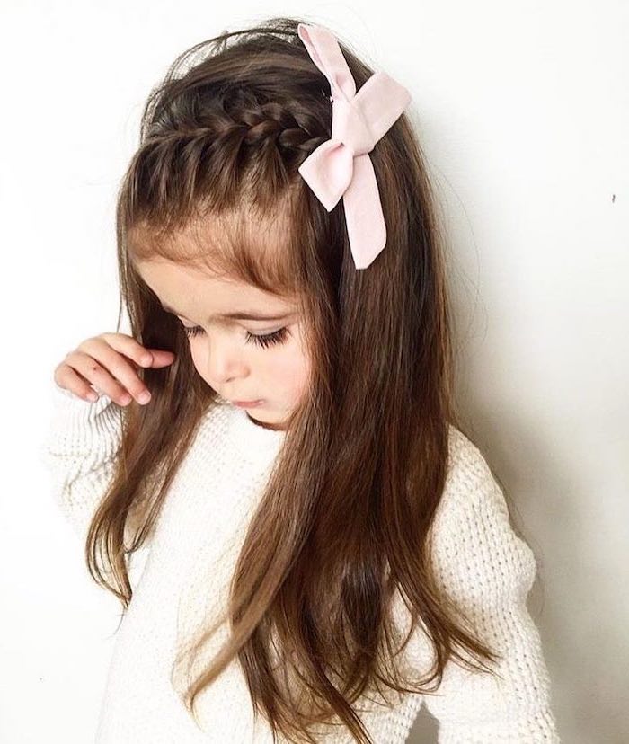 large pink bow, long brown hair, side braid, white sweater and background, easy hairstyles for girls