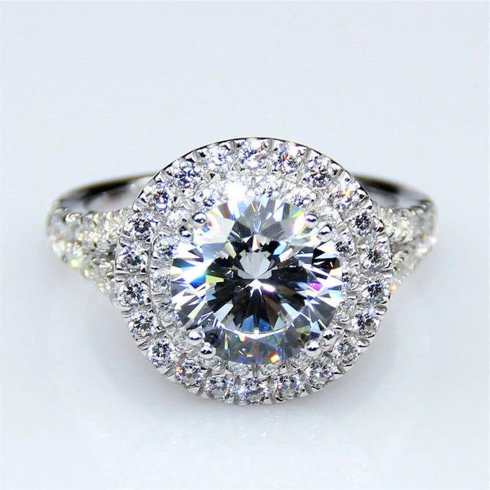 large round diamond, teardrop engagement ring, diamond studded band, white background
