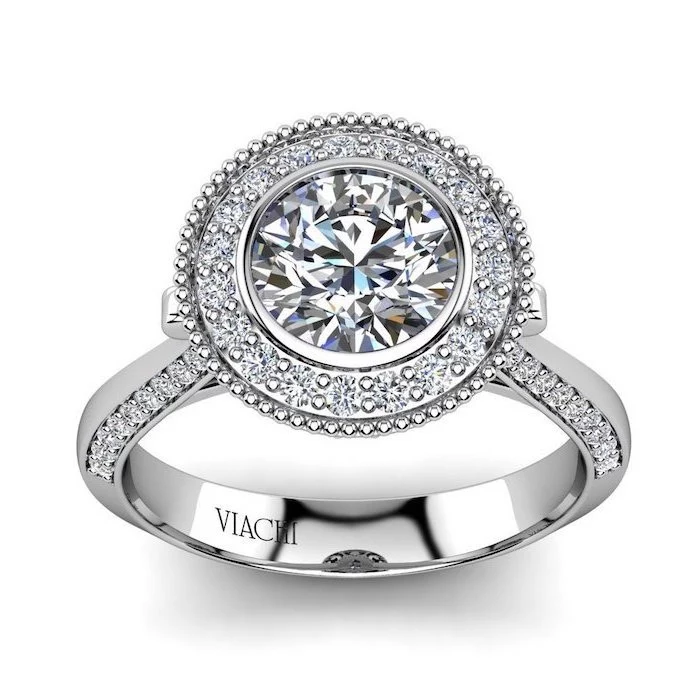 large round diamond, surrounded by smaller diamonds, teardrop engagement ring, white gold band