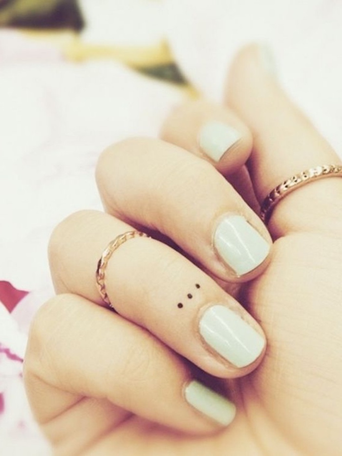 three small dots under the nail tattoo, golden rings on two finger, small tattoo ideas for men, mint green nail polish