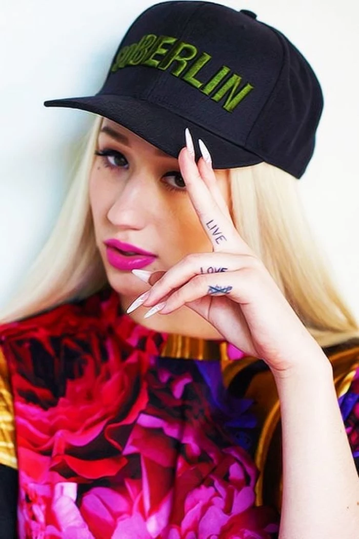 small tattoo ideas for men, live love crossed finger tattoos, iggy azalea staring at the camera, wearing a black cap