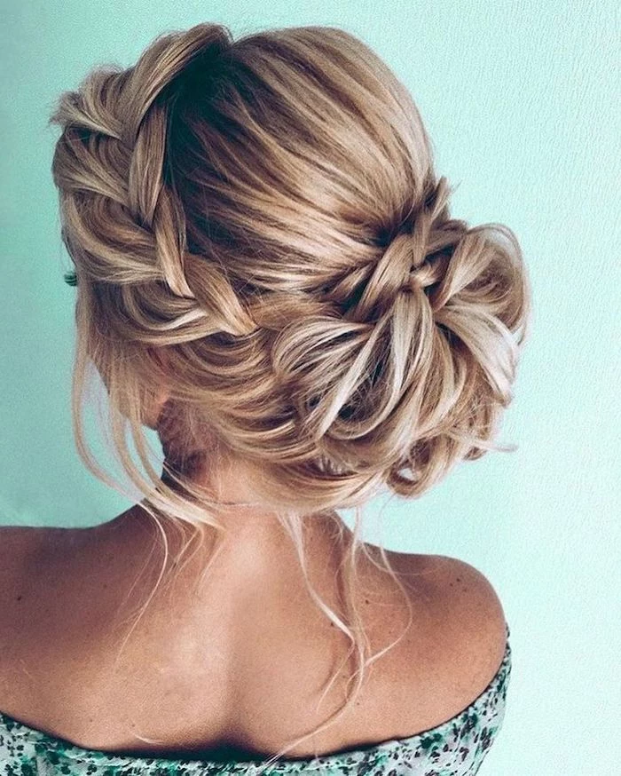 wedding hairstyle, low braided updo, blonde hair with highlights, floral top, green background