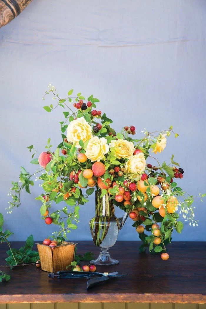 tall vintage vase, filled with flowers and fruits, in different colours, flower arrangements