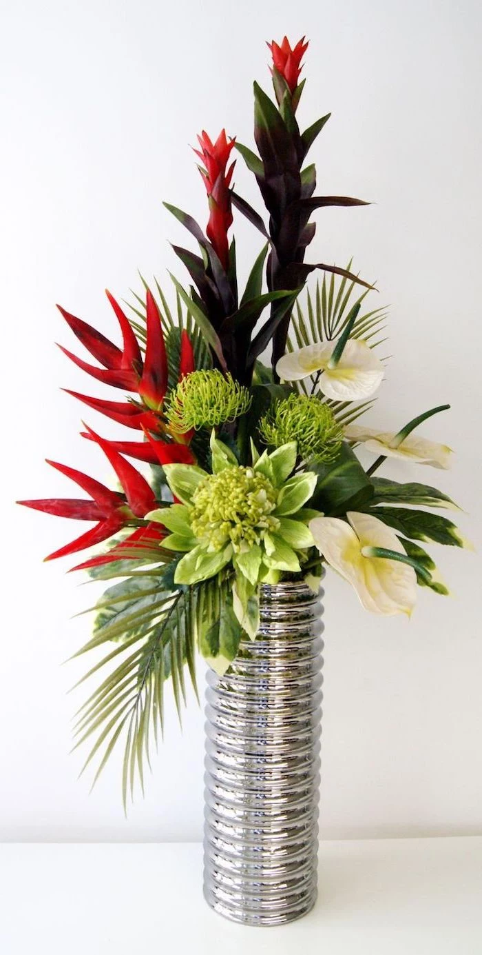 silver metal tall vase, flower arrangement ideas, lilies and red flowers bouquet, on a white countertop