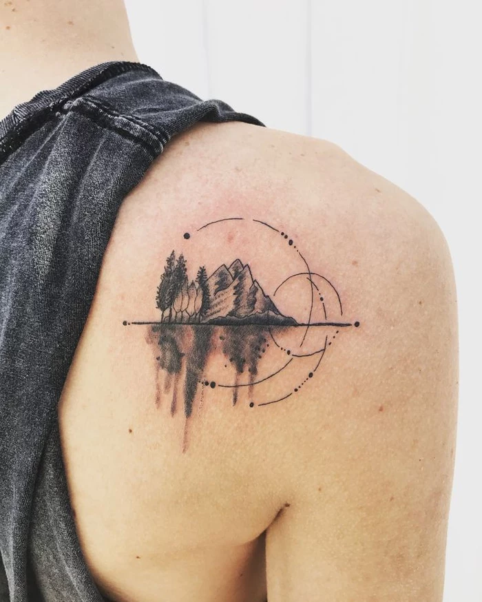 mountain landscape with circles, tattoo on the back of the shoulder, geometric flower tattoo