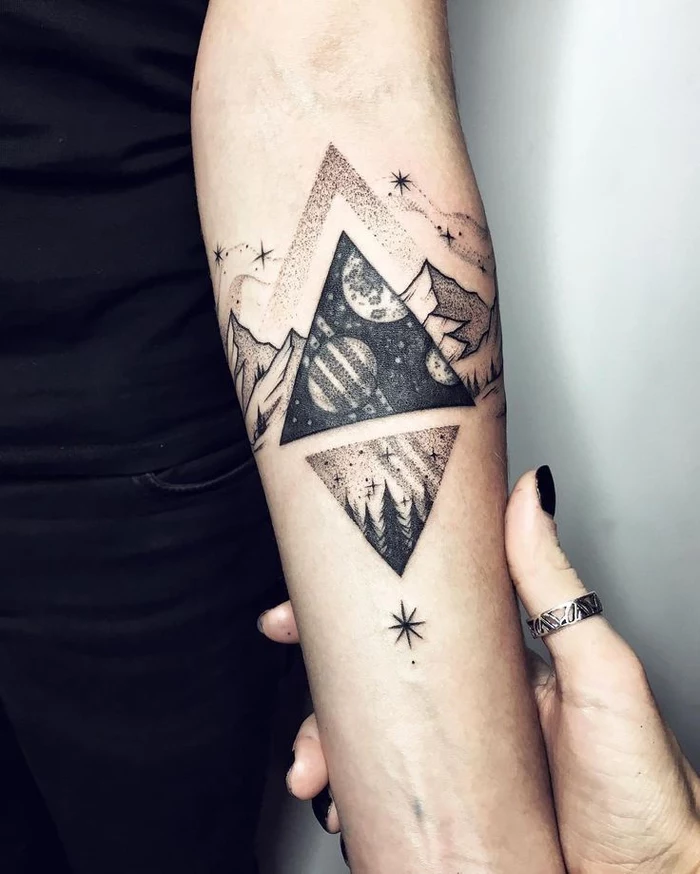 mountain landscape, with triangles and stars, tattoo on the forearm, geometric flower tattoo