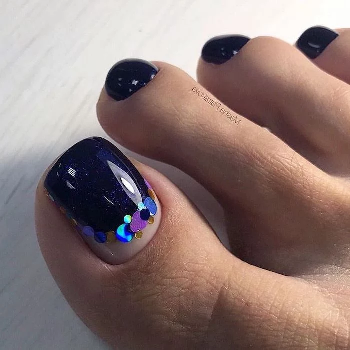 dark blue nail polish pedicure, colourful sequins on the toe, nude nail designs