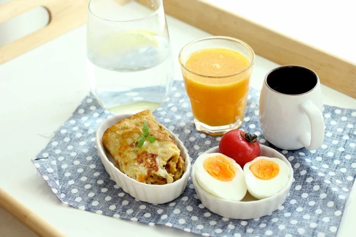 coffee cup, orange juice, bowl with boiled egg and tomato, omelette in a bowl, what should i have for lunch