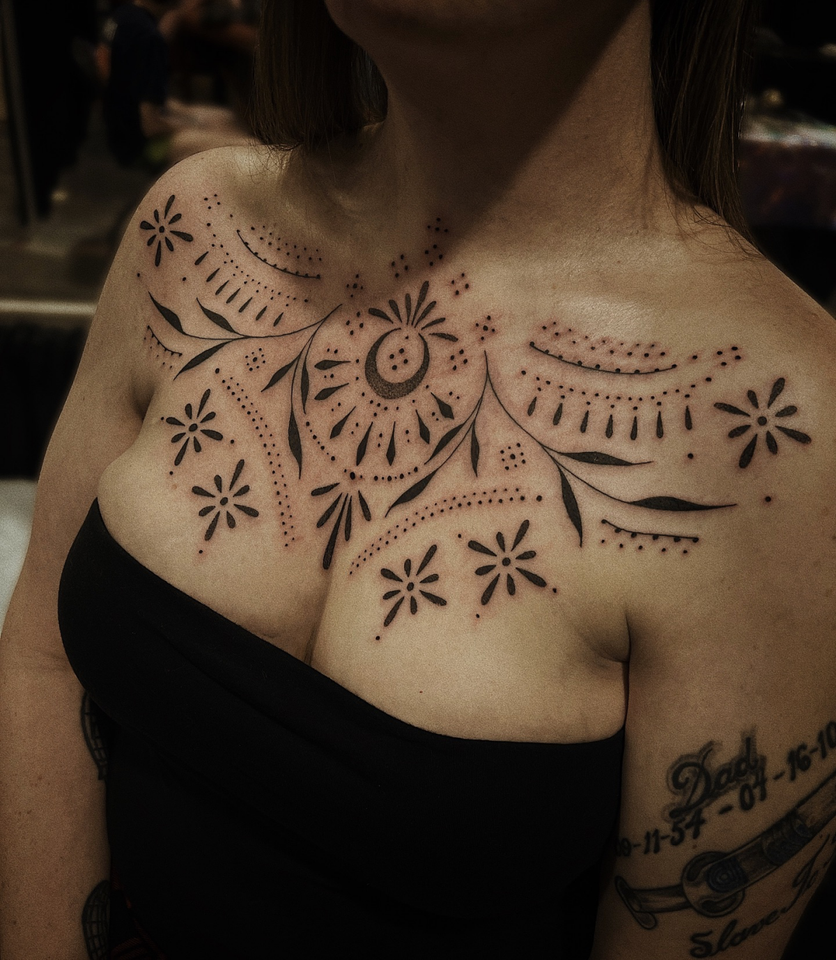 ornamental chest tattoo on woman