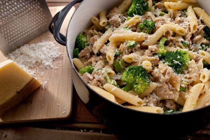 large black pot, full of pasta, with broccoli and meat, what should i have for lunch, parmesan cheese