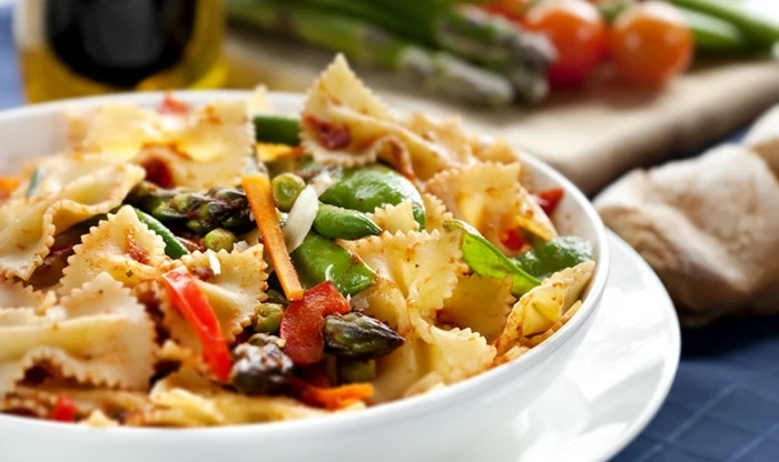 white bowl of pasta, with vegetables, 7 day healthy eating plan, on a white plate