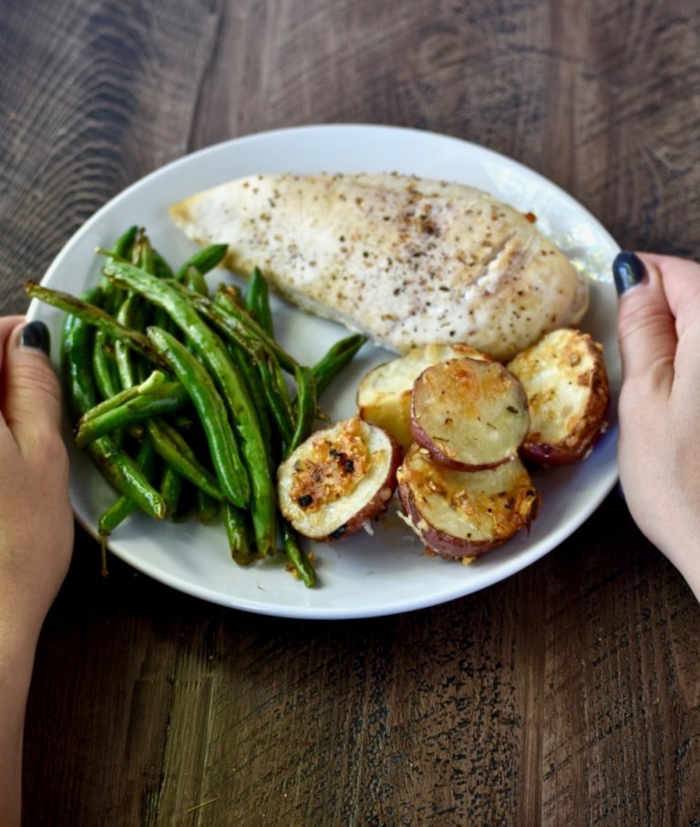 chicken fillet, red potatoes, and peas on the side, on a white plate, 7 day healthy eating plan