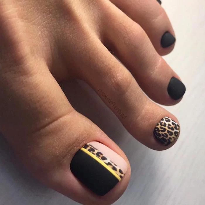 black matte nail polish, cool nail designs, leopard pattern pedicure, one foot photographed