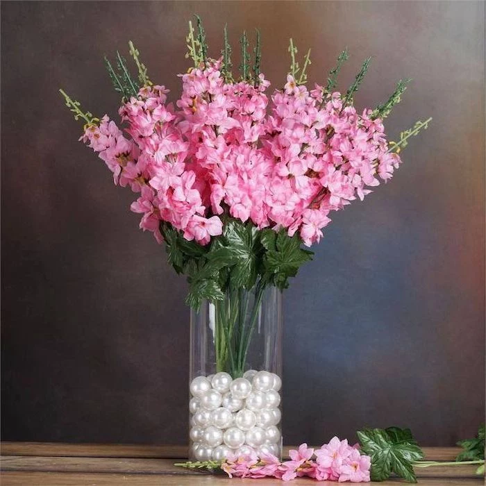 pink gladiolus flower bouquet, how to arrange flowers, tall round glass vase, filled with white pearls