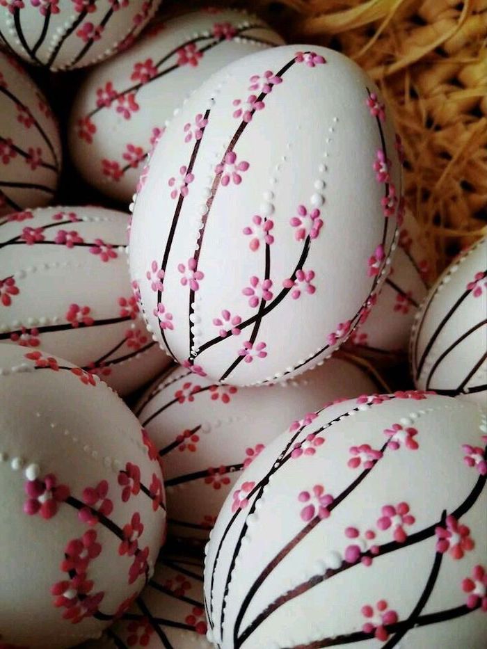 natural easter egg dye, pink blossoms, drawn on white eggs, inside a wooden basket