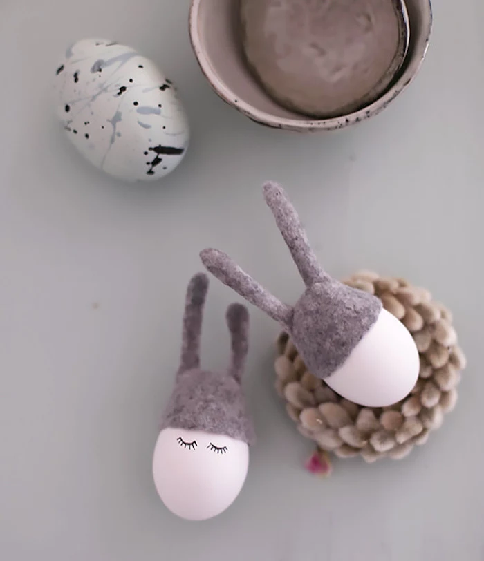 pink eggs, with eyelashes, drawn on them, natural easter egg dye, grey velvet ears, white blue and black egg