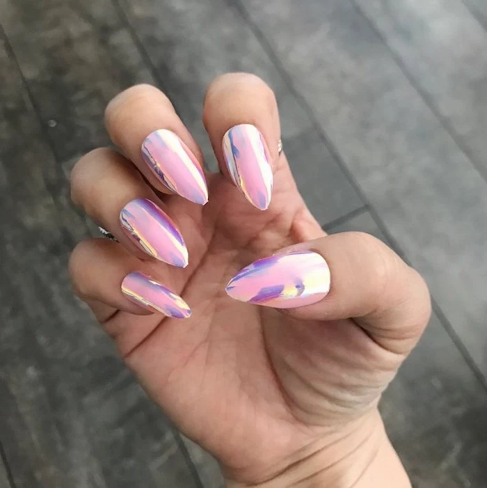 pink metallic nail polish, short stiletto nails, wooden floor in the background, nude matte nails