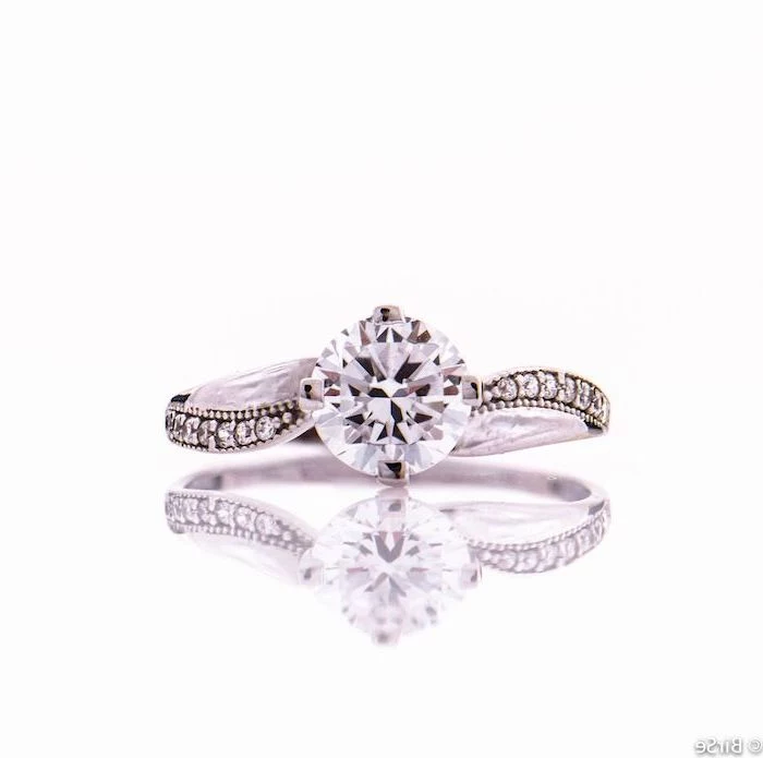 unique engagement rings for women, round diamond, diamond studded band, white background