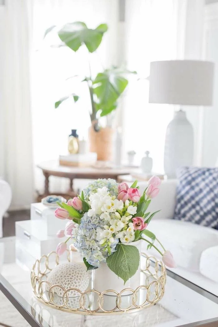 small flower bouquet, with pink white and blue flowers, in a small white vase, floral arrangements