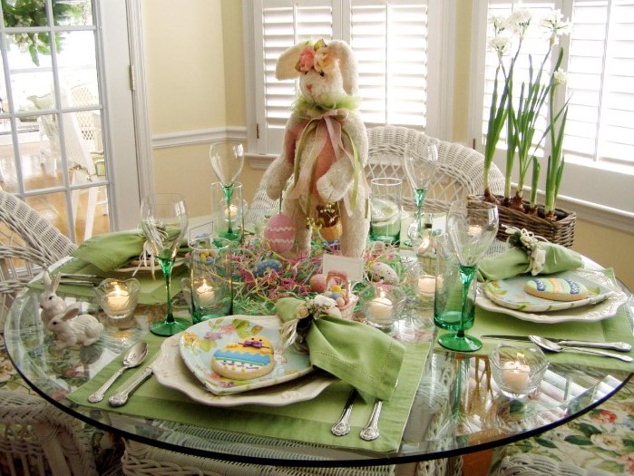 large plush bunny centerpiece, easter table centerpieces, green plate settings, tall wine glasses