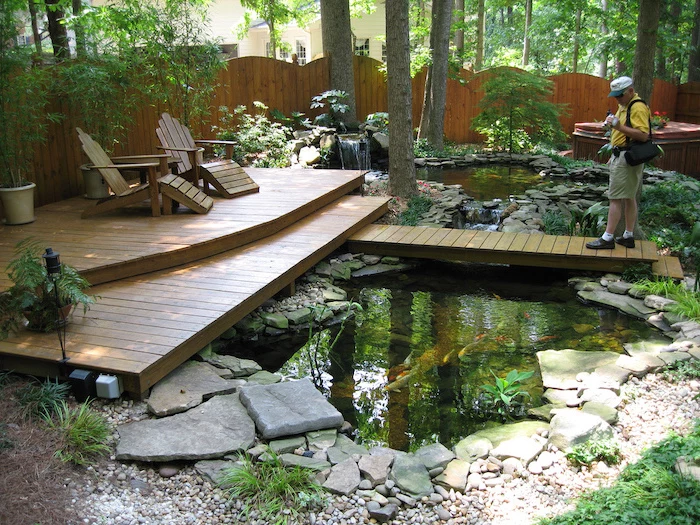 small ponds, wooden bridge over them, wooden lounge chairs, backyard ideas for small backyards