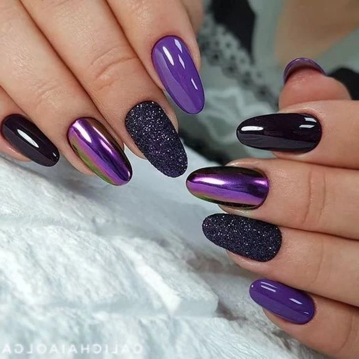 purple and black chrome nail polish, black glitter nail polish on two nails, pink and gold nails