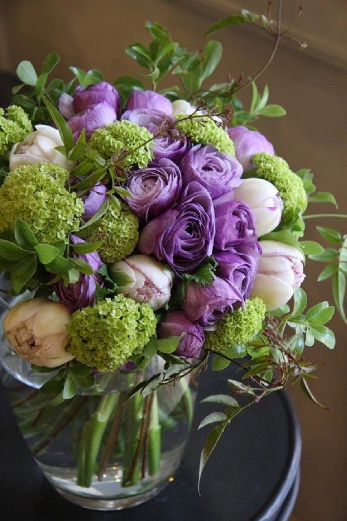 purple and white peonies, large flower bouquet, large glass round vase, beautiful flower arrangements, on a black table
