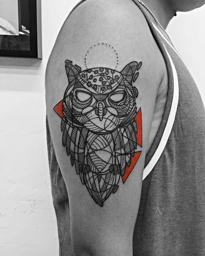 large red and black owl tattoo, geometric tattoo meaning, tattoo on the shoulder, man wearing a tank top