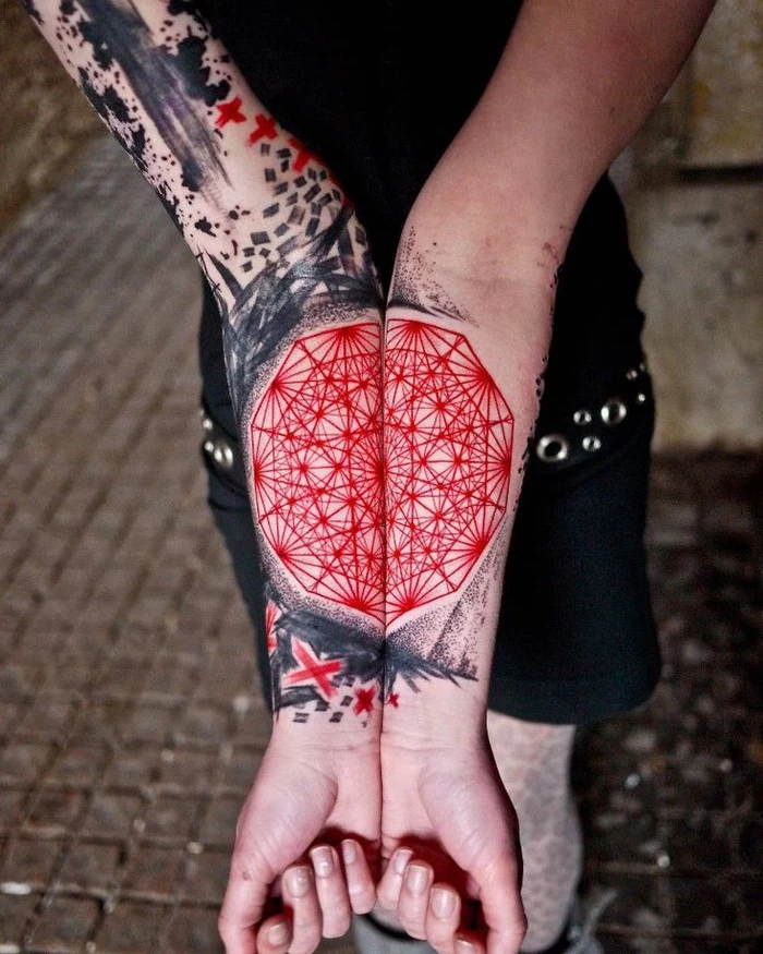 large red and black tattoo, on the wrist and forearm, geometric tattoo meaning, paved street
