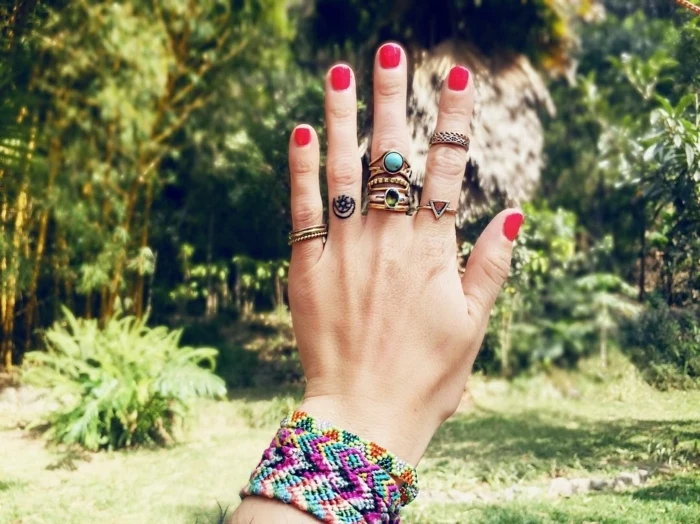 red nail polish, colourful bracelets, cute finger tattoos, crescent moon and star, ring finger tattoo