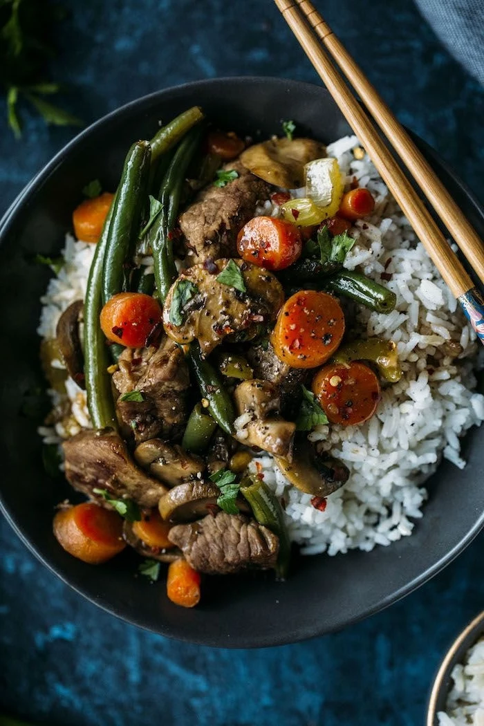 large black pot, full of white rice, grilled vegetables and meat, healthy eating meal plan