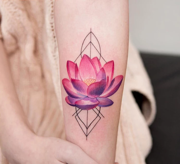 pink and purple lotus flower, surrounded by geometrical shapes, geometric tattoo meaning, forearm tattoo