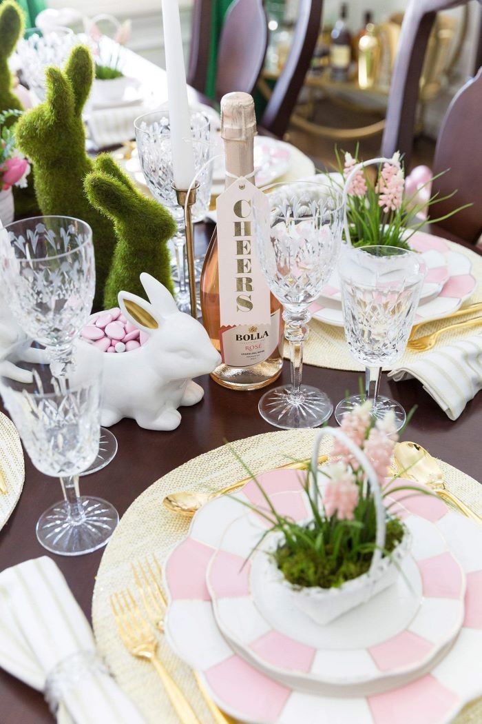 bottle of rose wine, pink and white plate settings, easter table centerpieces, green bunny figurines