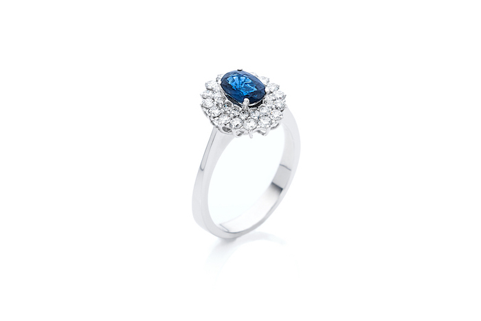 large sapphire in the middle, flower shaped diamonds, white gold band, non traditional wedding rings