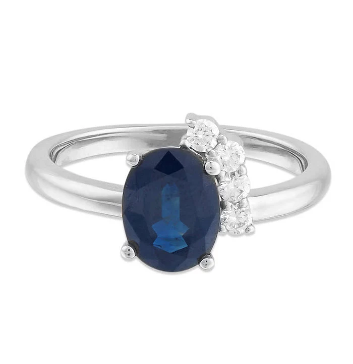 round sapphire in the middle, smaller diamonds, white gold band, non traditional wedding rings
